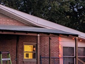 Nighttime catio construction with brick walls