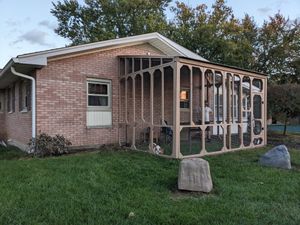 Cozy outdoor cat enclosure with platforms.